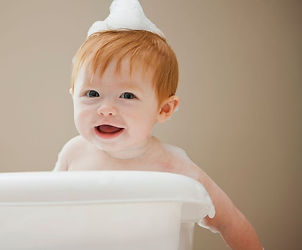 Bébé assis avec une serviette sur la tête